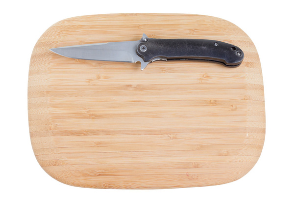 Tabla de cortar de bambú con un cuchillo
. - Foto, Imagen
