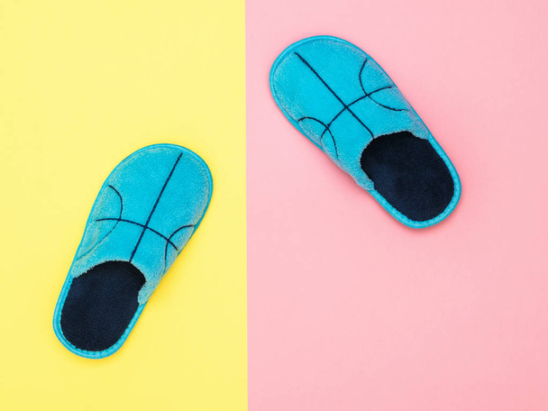 Blue house Slippers on pink and yellow background. The view from the top. Flat lay. - Photo, Image