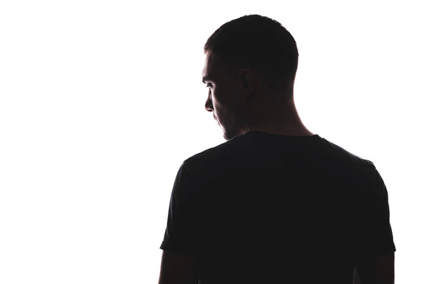 Silhouet portret van de mens met zijn rug op zoek weg, geïsoleerd op een witte achtergrond - Foto, afbeelding
