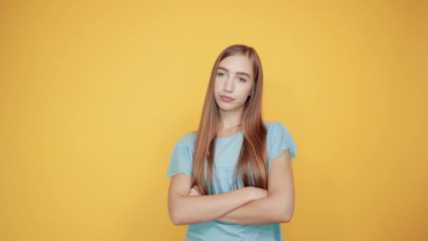lány barna kék póló több mint elszigetelt narancssárga háttér mutatja érzelmek - Felvétel, videó