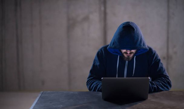 talented hacker using laptop computer while working in dark offi - Foto, Imagem