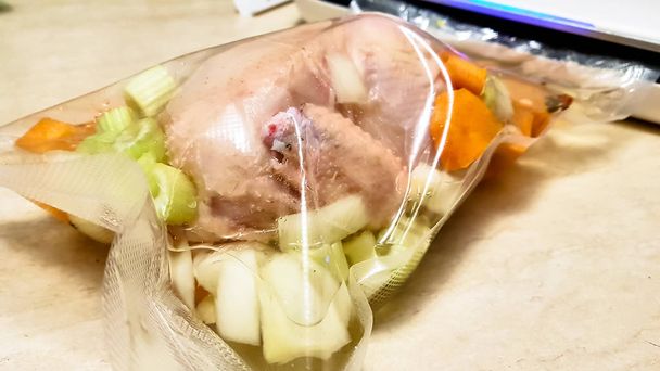 Chicken with vegetables in a vacuum bag for sous vide. - Photo, Image
