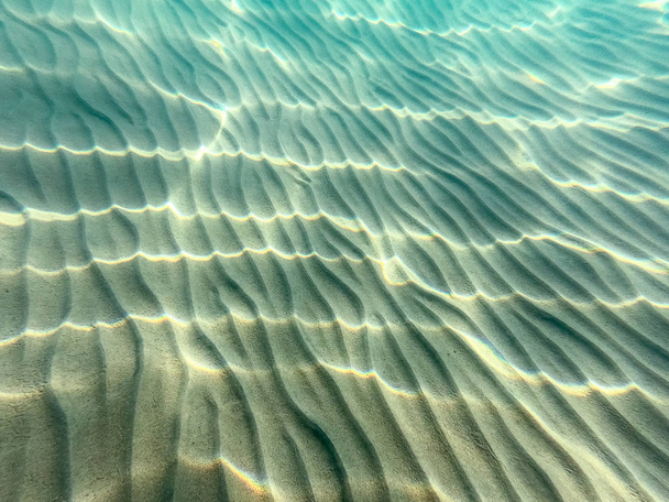 Clear water. underwater background with sandy sea bottom. Beautiful texture of the sea and ocean water. - Photo, Image