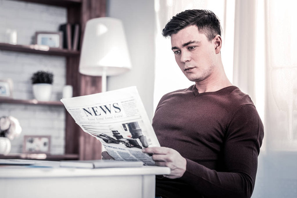 Interested man reading fresh newspaper at home - Fotografie, Obrázek