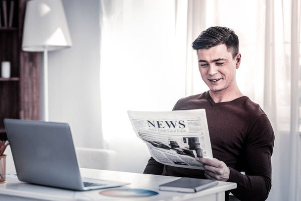 Smiling man with stylish haircut being amused by information - Fotoğraf, Görsel