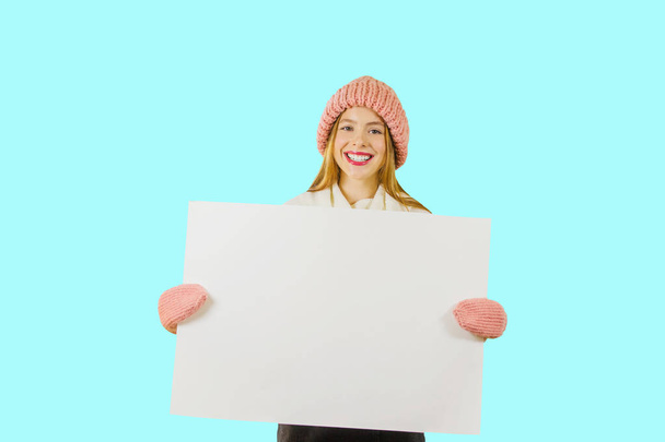 Beautiful girl holding a blank poster for text or advertising - Foto, Imagen