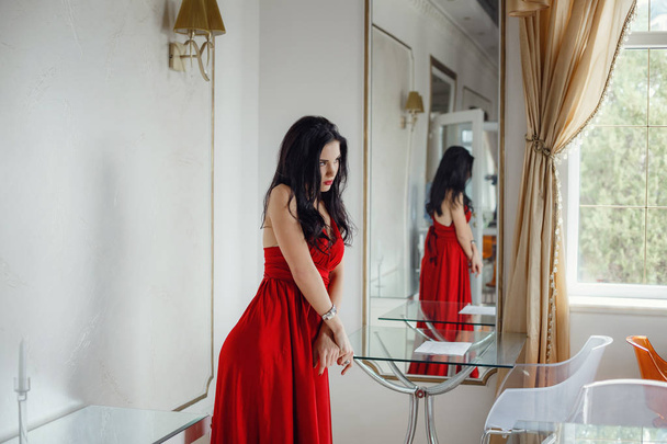 Beautiful sexy woman in red dress looking happy posing. - Foto, Imagen