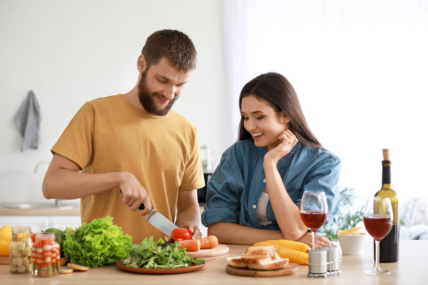 Young couple cooking together in kitchen - Foto, imagen