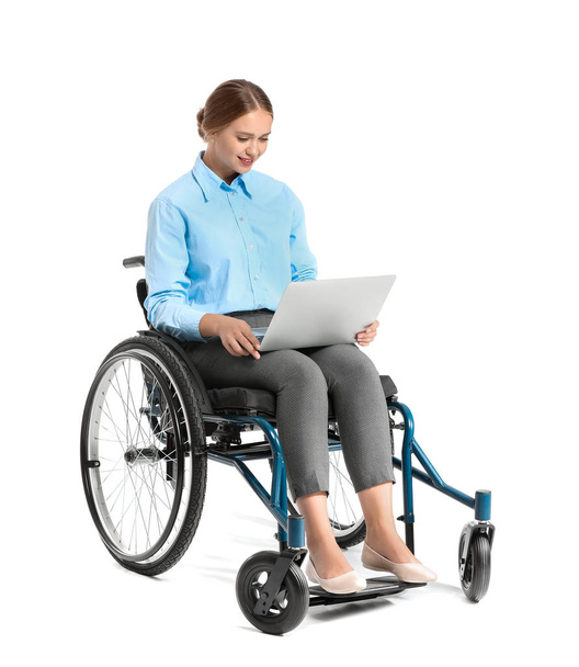 Beautiful businesswoman with laptop in wheelchair on white background - Photo, image