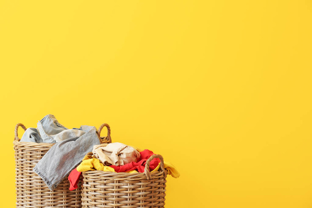 Baskets with dirty laundry on color background - Photo, Image