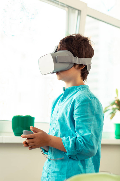 Schoolboy being inside of the virtual reality. - Fotografie, Obrázek