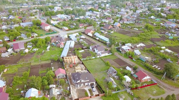 Top view on panorama of this village with cottages. Clip. Beautiful landscaped village for summer holiday in country with whole family - 写真・画像