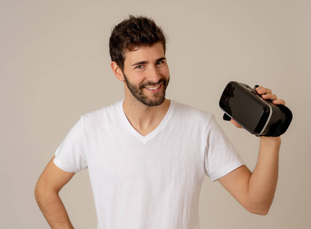 Virtual reality experience. Young caucasian bearded man happy to use VR goggles feeling excited about simulation and exploring virtual life. In New technology Virtual Augmented Reality concept. - Fotoğraf, Görsel