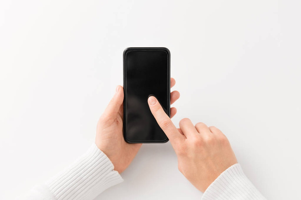 close up of hands with black smartphone - Фото, изображение
