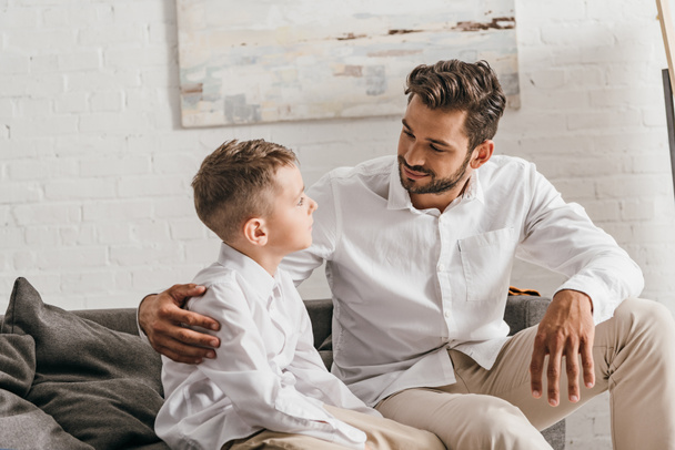 father and son in white shirts looking at each other - Photo, Image
