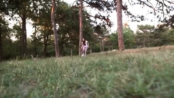 Girl plays ball in a forest glade - 映像、動画
