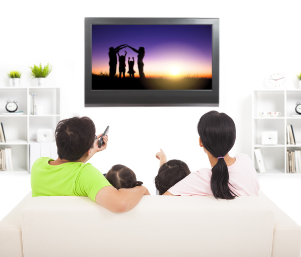 family watching the tv in living room - Photo, Image