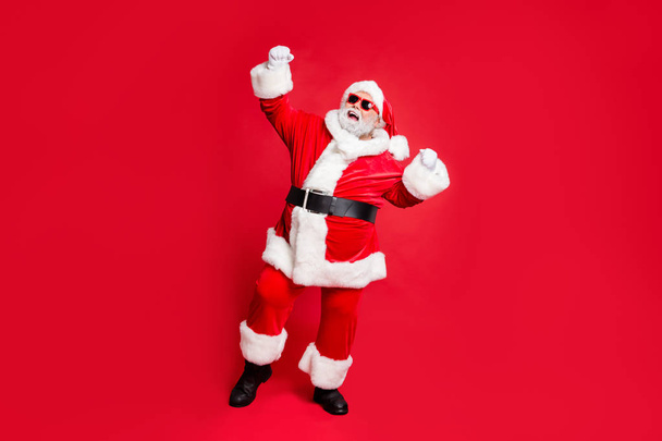 Full length body size view of his he cheerful cheery carefree fat overweight plump gray-haired bearded man St Saint Nicholas having fun great fairy occasion isolated over bright vivid shine red - Fotografie, Obrázek