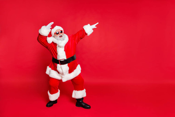 Full length body size view of his he nice attractive cheerful cheery careless bearded Santa having fun rejoicing fairy eve noel isolated over bright vivid shine red background - Foto, immagini