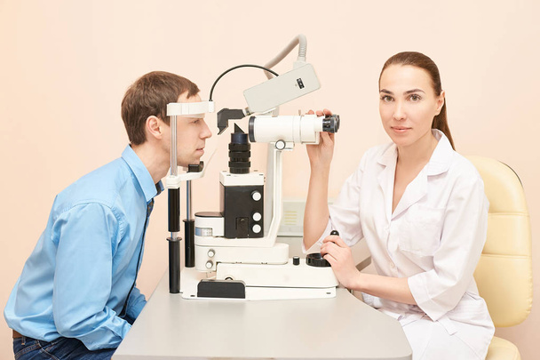 Eye ophthalmologist exam. Eyesight recovery. Astigmatism check concept. Ophthalmology diagmostic device. Beauty girl portrait in clinic. Man patient - Foto, Imagem
