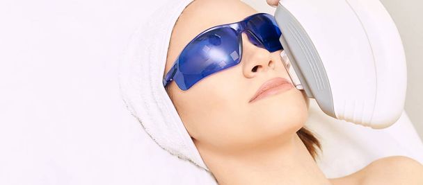Laser facial hair removal. Cosmetology ipl device. Woman body in - Photo, Image