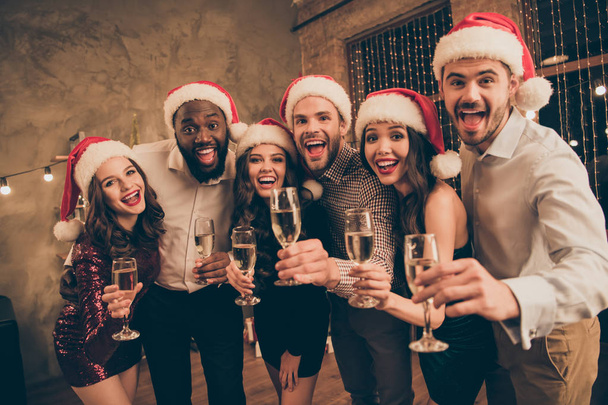 Portrait of leaning guy and ladies enjoy christmas night celebrate x-mas noel give toast screaming wearing dress shirt cap pants in house with newyear illumination decoration indoors - 写真・画像