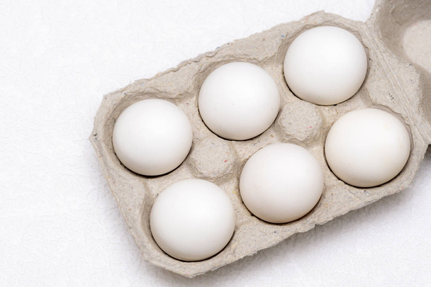 Six white eggs in a cardboard tray - 写真・画像