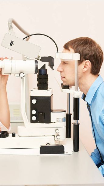 Eye ophthalmologist exam. Eyesight recovery. Astigmatism check concept. Ophthalmology diagmostic device. Beauty girl portrait in clinic. Man patient - Foto, afbeelding