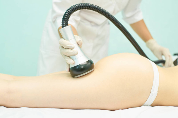 Vacuum massage device. Anti cellulite body correction treatment. Loss weight apparatus. Woman and doctor at medicine salon - Φωτογραφία, εικόνα