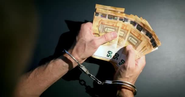 financial crime concept - hands with handcuffs counting euro money - Footage, Video