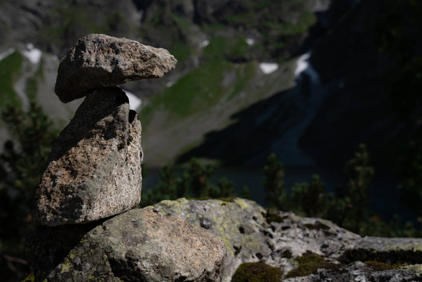 Stone cairn on the mountains background, three stones tower - Foto, Imagem