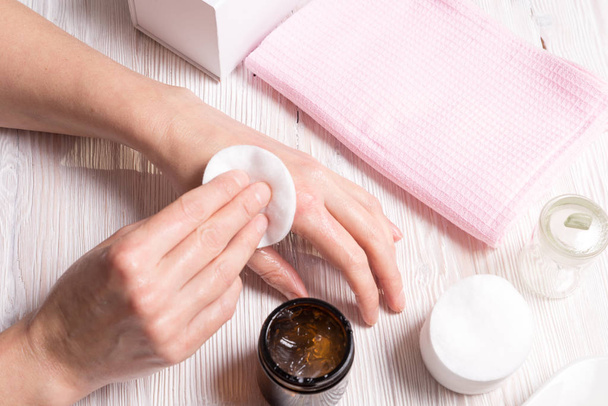 Woman making care cream mask for hands  - 写真・画像