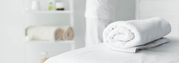 panoramic shot of white towel on massage mat in spa  - Photo, Image