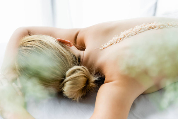 sırtta deniz tuzu ile masaj mat yatan kadın  - Fotoğraf, Görsel