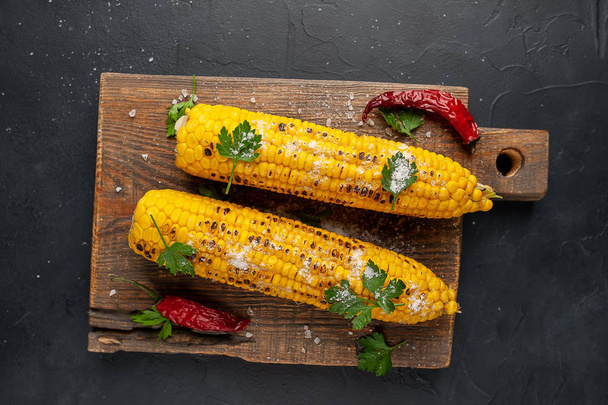 fresh corn with chili peppers on a wooden board - Photo, image