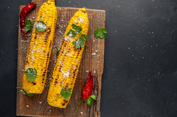 fresh corn with chili peppers on a wooden board - Photo, Image