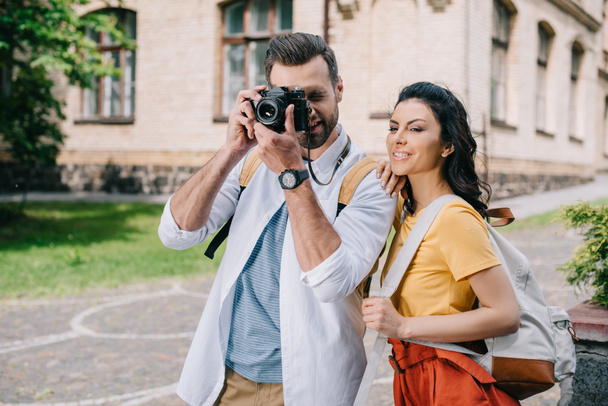 bearded man covering face while taking photo near woman  - Photo, Image
