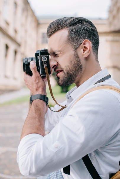 side view of bearded man taking photo on digital camera  - Φωτογραφία, εικόνα