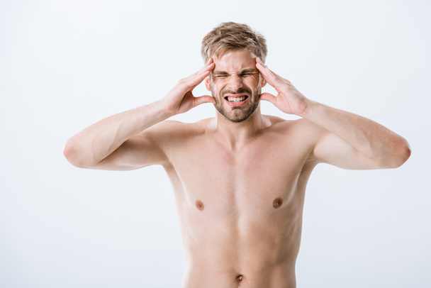 front view of shirtless man with headache touching temples isolated on grey - Foto, imagen