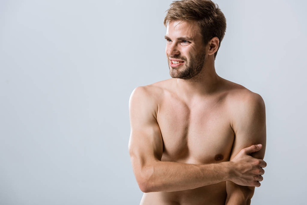 shirtless muscular man with pain in arm isolated on grey - Foto, imagen