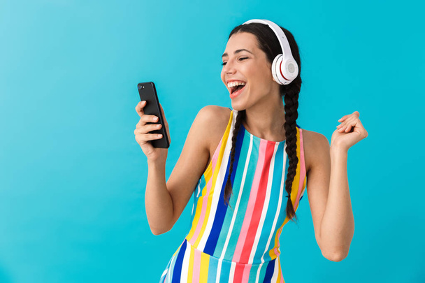 Image of nice beautiful woman with pigtails dancing while using headphones and cellphone - Photo, image