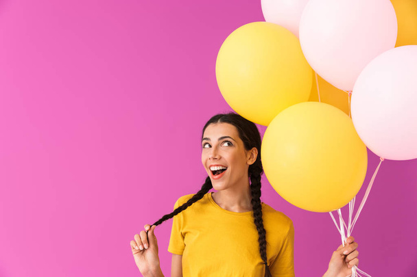 Lovely young brunette girl holding bunch of air balloons - Fotografie, Obrázek
