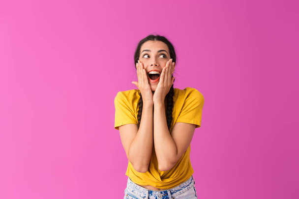 Image of surprised happy woman smiling and touching her cheeks with hands - Foto, Bild