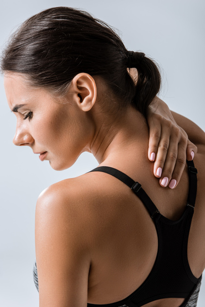 attractive sportswoman with neck pain isolated on grey - Fotografie, Obrázek