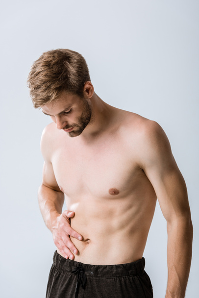 shirtless sportman with abdominal pain isolated on grey - Zdjęcie, obraz