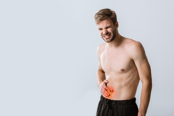 shirtless sportman with abdominal pain isolated on grey - Fotó, kép