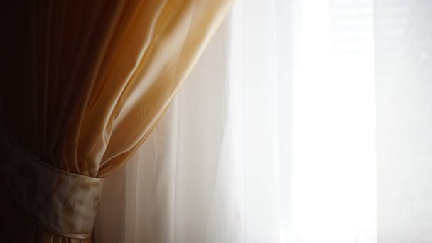 White tulle with a brown curtain fixed holder, light background. - Photo, Image