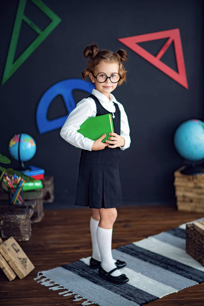 Smart girl with textbook in school - Zdjęcie, obraz