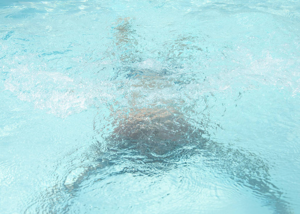 man swimming under water in the pool. man under water in the pool - Fotó, kép