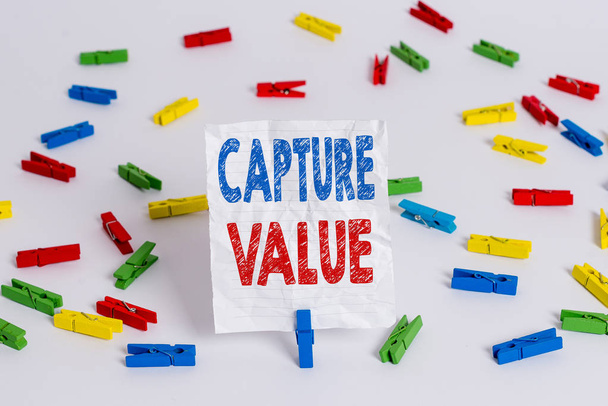 Text sign showing Capture Value. Conceptual photo Customer Relationship Satisfy Needs Brand Strength Retention Colored clothespin papers empty reminder white floor background office. - Photo, Image